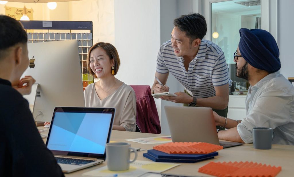 A diverse team collaborating and brainstorming in a modern office setting.