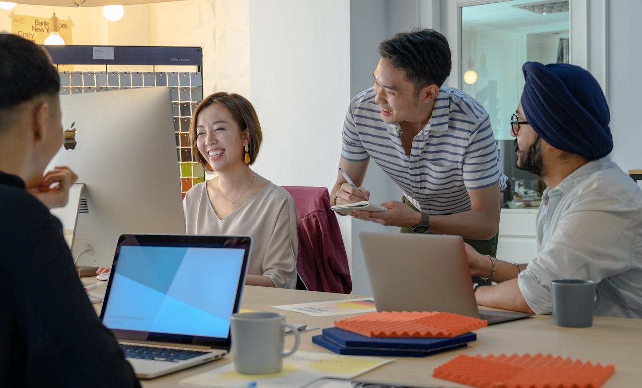 A diverse team collaborating and brainstorming in a modern office setting.